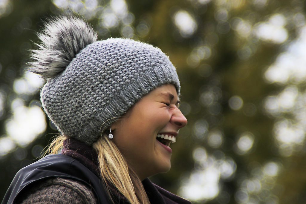 Smiling woman in winter white teeth