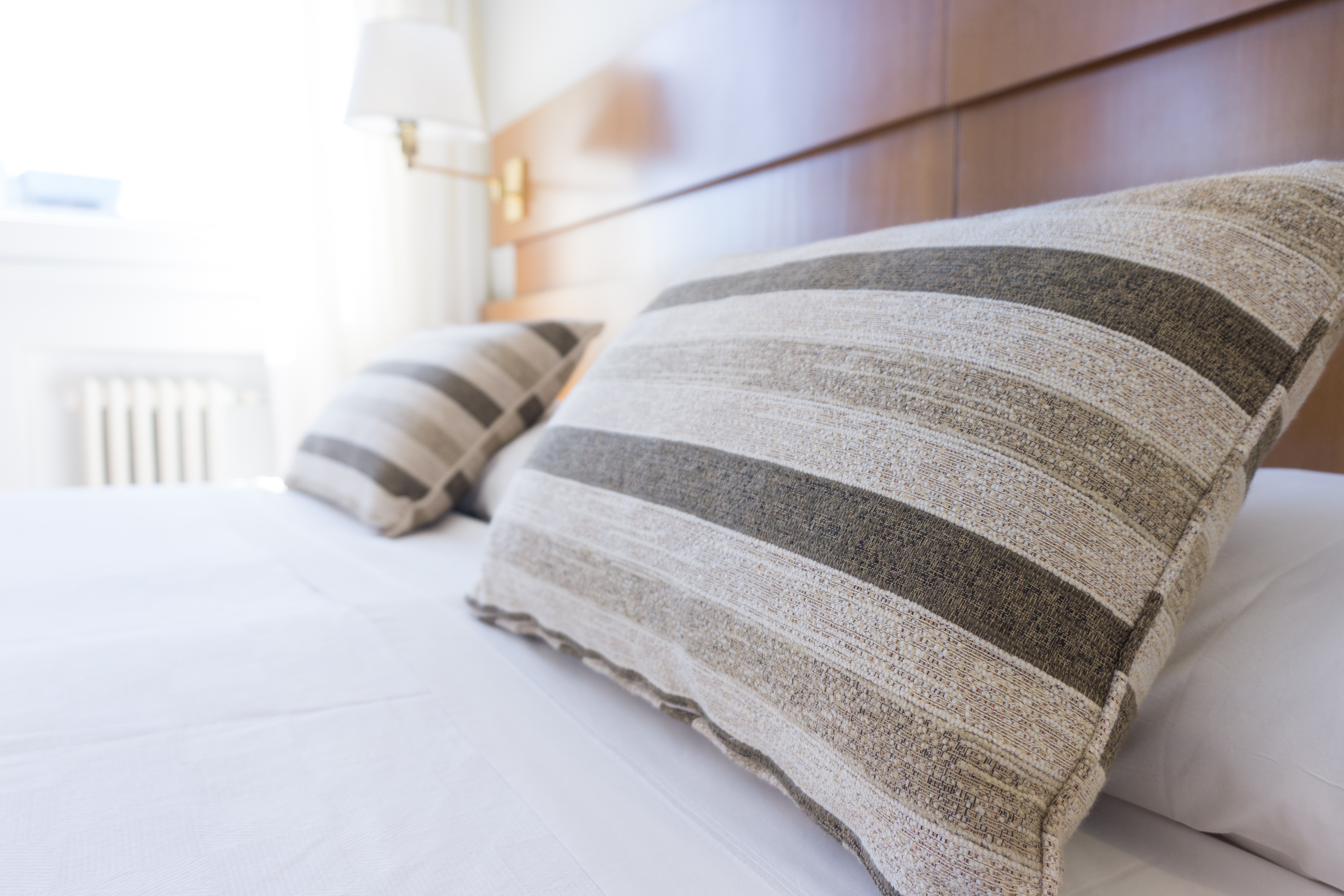 grey striped pillows on bed