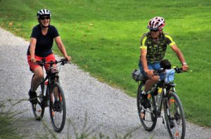 Active older couple rides bikes and laughs