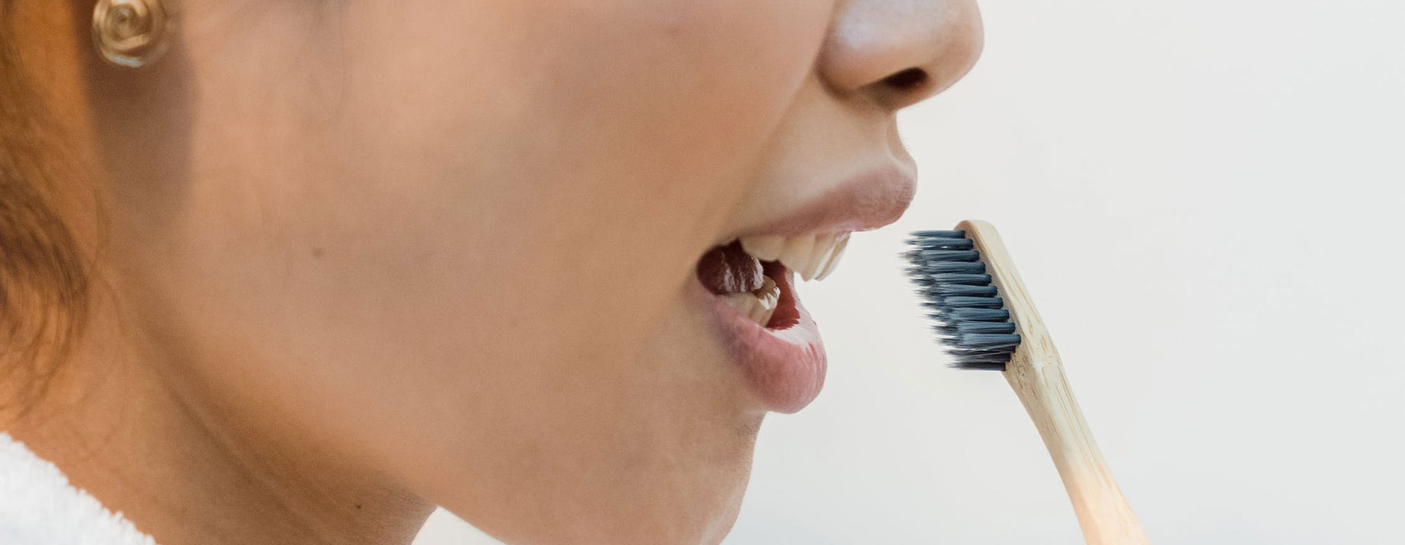 woman wish toothbrush near teeth